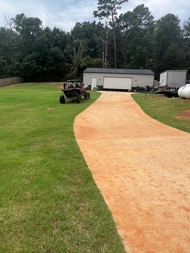 view of yard with a garage and an outdoor structure