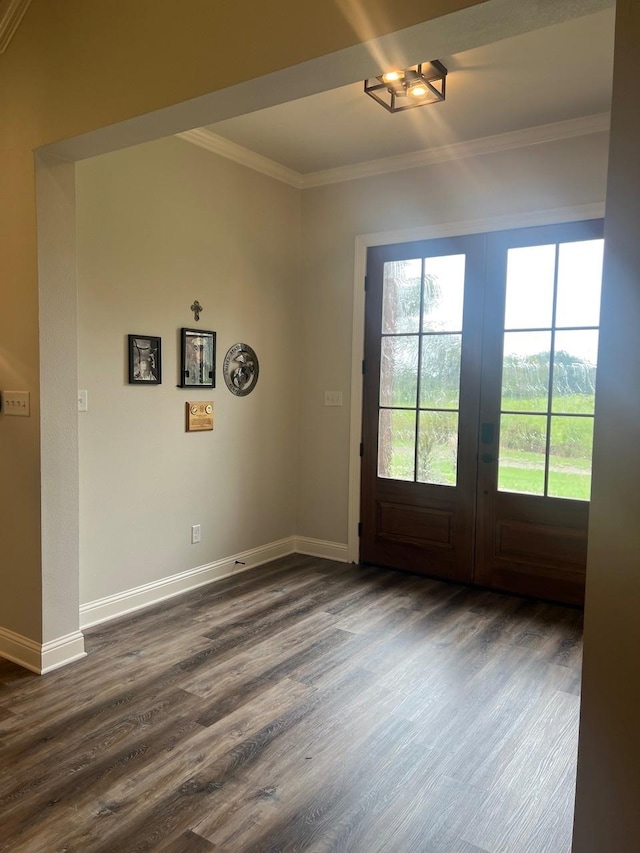 doorway to outside with dark wood finished floors, french doors, crown molding, and baseboards