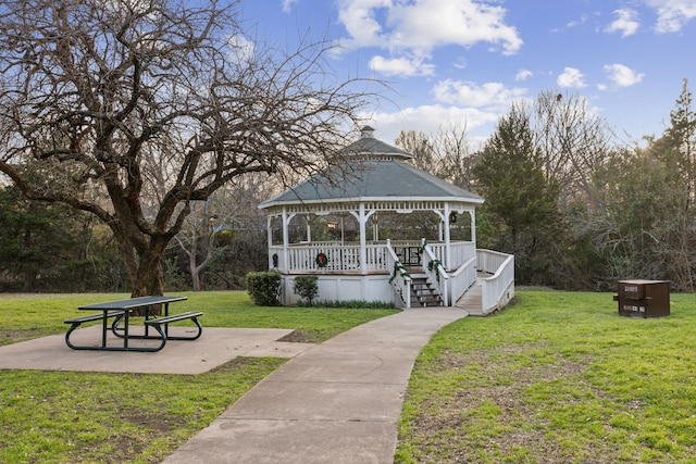 view of property's community with a yard, a gazebo, and a patio