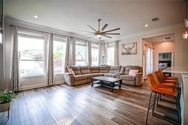 living area featuring visible vents, dark wood-style flooring, crown molding, and recessed lighting