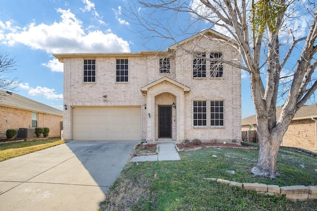 traditional home with driveway, a garage, brick siding, central air condition unit, and a front yard