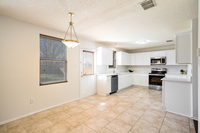 kitchen featuring white cabinetry, visible vents, appliances with stainless steel finishes, and light countertops