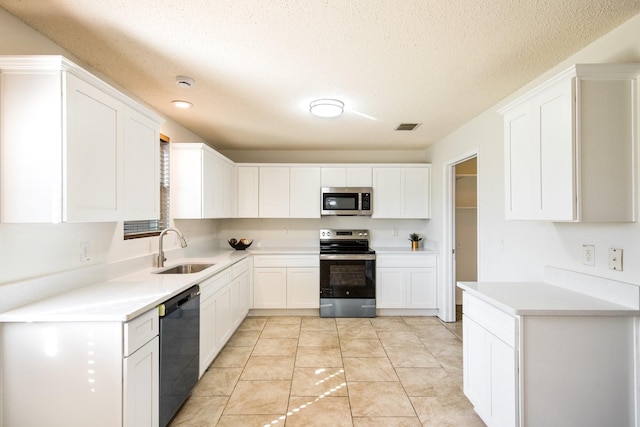 kitchen with visible vents, appliances with stainless steel finishes, white cabinets, and a sink