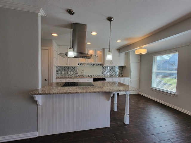 kitchen with black electric cooktop, a sink, white cabinets, and island range hood