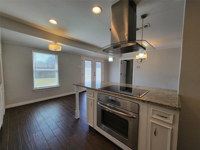 kitchen featuring island range hood, dark wood-style flooring, oven, black electric cooktop, and white cabinetry