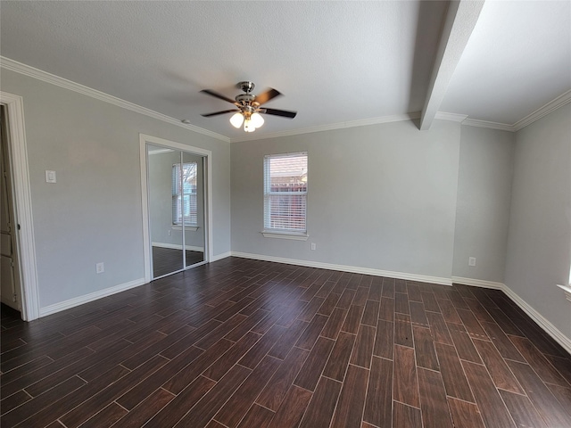 empty room featuring beam ceiling, a ceiling fan, wood tiled floor, a textured ceiling, and baseboards