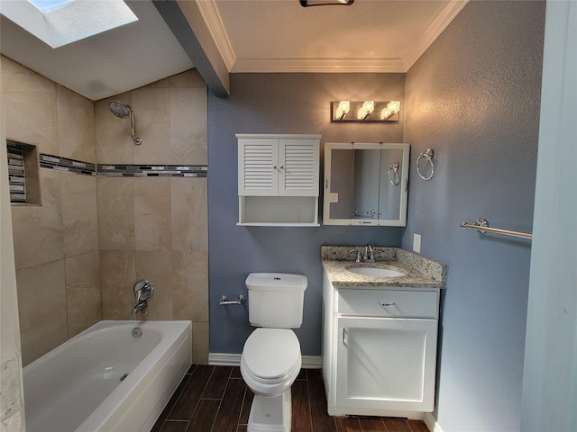 bathroom with a skylight, baseboards, toilet, ornamental molding, and wood finish floors