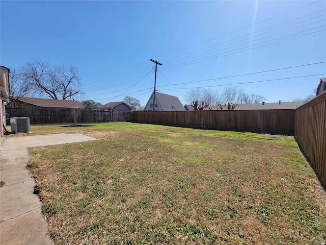 view of yard with a patio, a fenced backyard, and central air condition unit