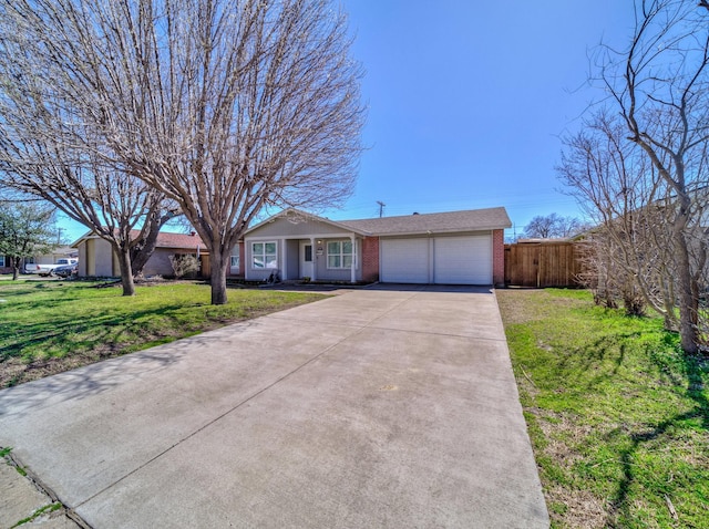 single story home featuring brick siding, an attached garage, fence, driveway, and a front lawn