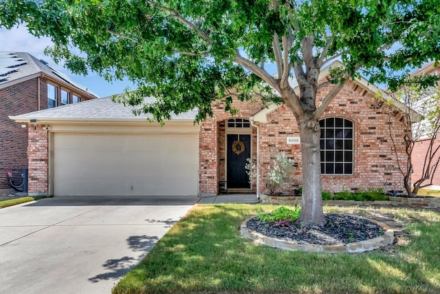 view of front of house featuring a garage, a shingled roof, concrete driveway, and brick siding