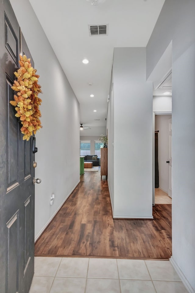 corridor featuring tile patterned flooring, visible vents, and recessed lighting