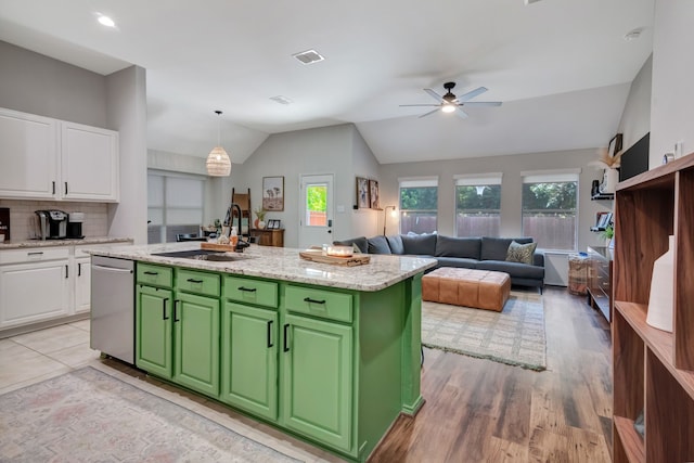 kitchen featuring a sink, visible vents, white cabinets, stainless steel dishwasher, and green cabinetry