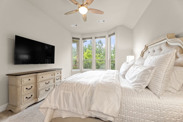 bedroom with a ceiling fan, visible vents, vaulted ceiling, and light carpet