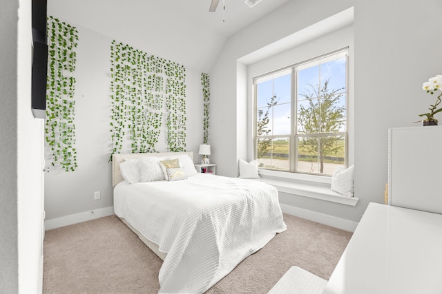 carpeted bedroom featuring lofted ceiling, ceiling fan, and baseboards