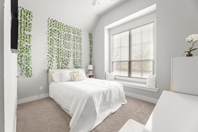 carpeted bedroom with a ceiling fan, lofted ceiling, and baseboards