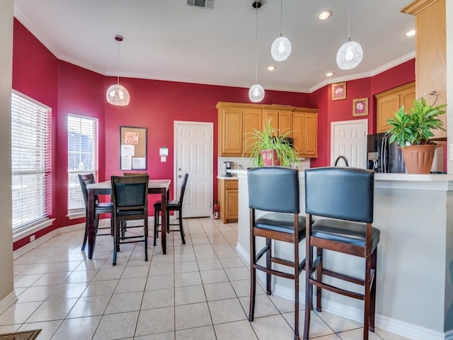 kitchen featuring visible vents, decorative light fixtures, baseboards, and light tile patterned floors