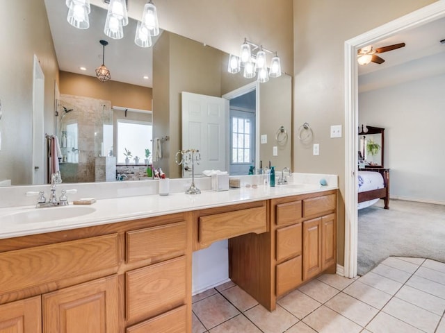 ensuite bathroom featuring a healthy amount of sunlight, ensuite bath, a sink, and a shower stall