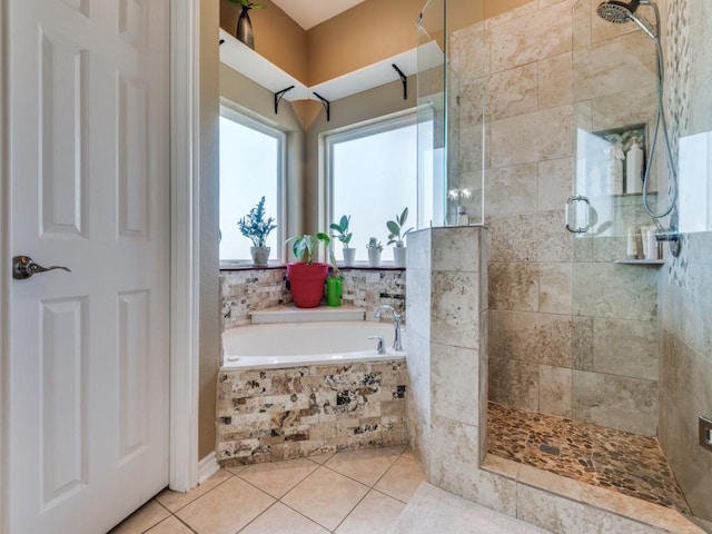 full bath featuring a garden tub, tile patterned flooring, and a shower stall