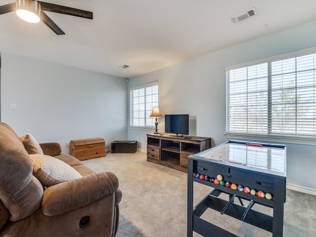 living area with carpet, visible vents, and baseboards