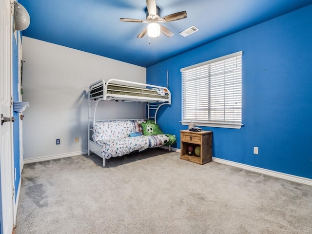 unfurnished bedroom with a ceiling fan, carpet flooring, and baseboards