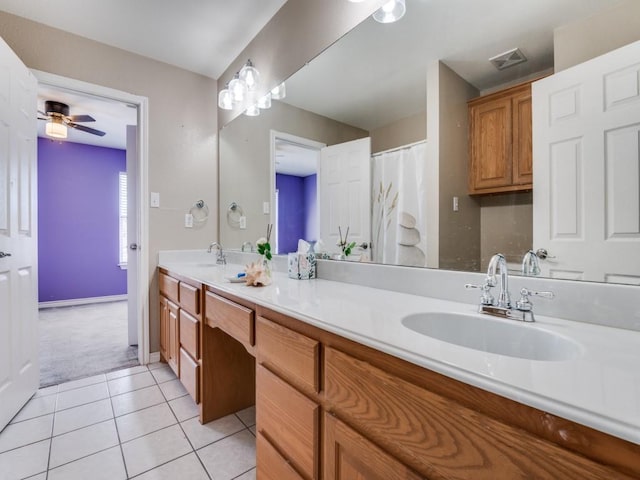 full bath featuring double vanity, a sink, visible vents, and tile patterned floors