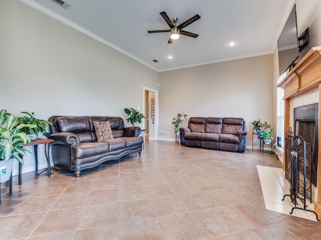 living room featuring ornamental molding, a fireplace, light tile patterned flooring, and baseboards