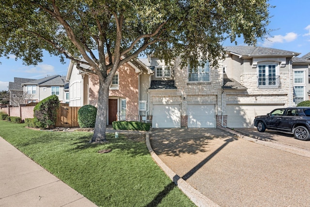 view of front of property featuring brick siding, fence, driveway, and an attached garage