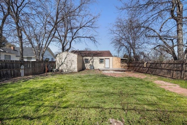 view of yard with a fenced backyard and an outdoor structure