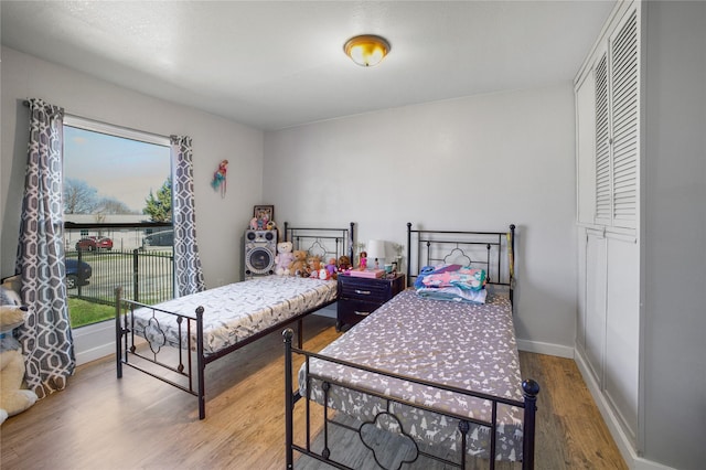 bedroom featuring baseboards and wood finished floors