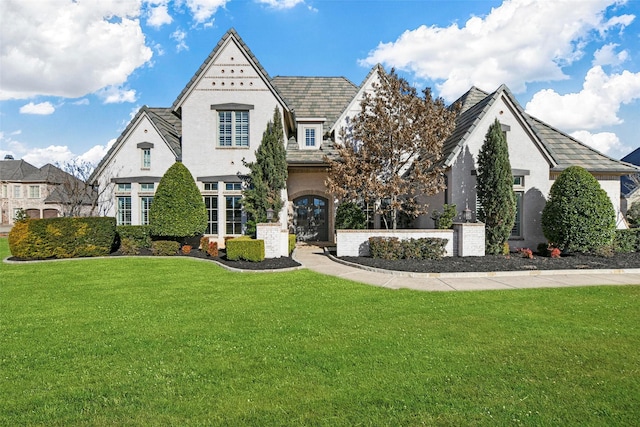 view of front of home with a front yard and stucco siding