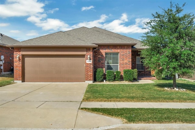 view of front of home featuring brick siding, a shingled roof, concrete driveway, a front yard, and a garage