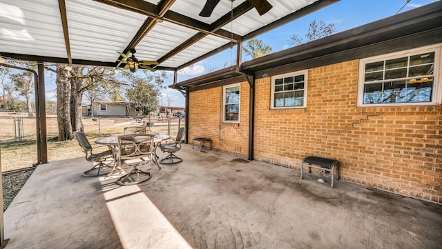 view of patio featuring outdoor dining area and fence