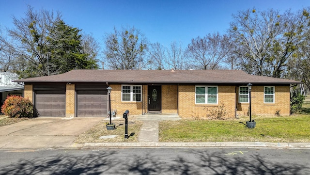 ranch-style home with a front lawn, concrete driveway, brick siding, and a garage