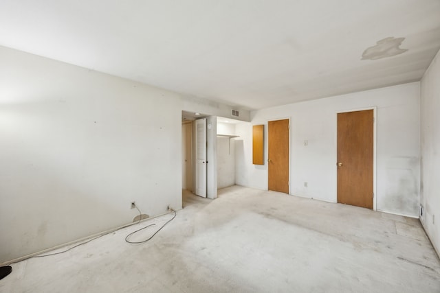 unfurnished bedroom featuring visible vents