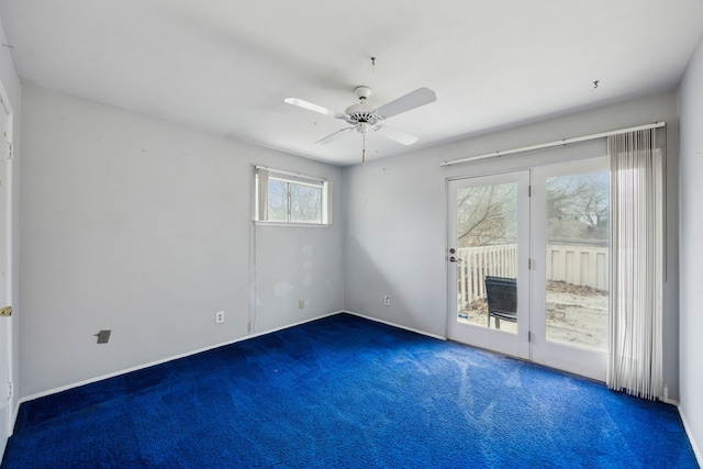 empty room featuring a ceiling fan and carpet floors