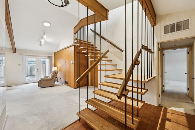 stairway featuring beamed ceiling, carpet flooring, french doors, and visible vents