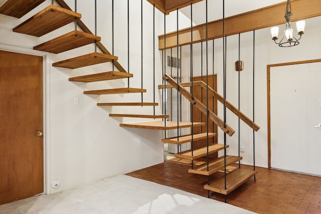 stairs with a chandelier