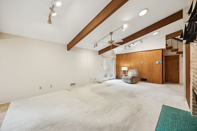 living area featuring visible vents, vaulted ceiling with beams, carpet, stairway, and rail lighting