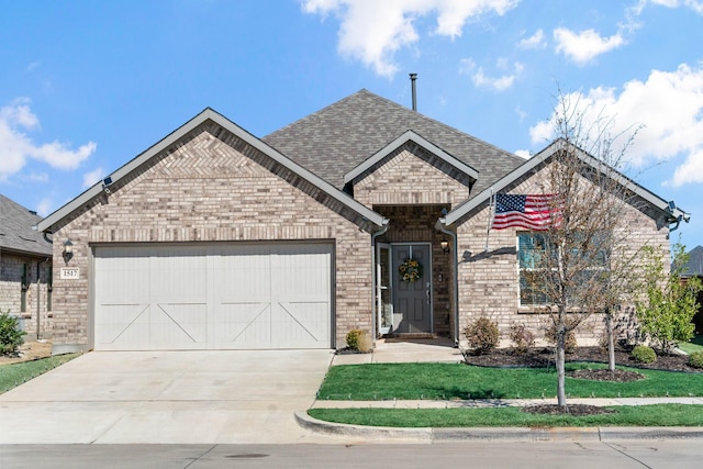 french country style house featuring brick siding, a garage, driveway, and a shingled roof