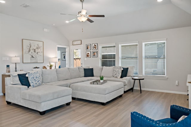 living area featuring light wood-style floors, vaulted ceiling, baseboards, and ceiling fan