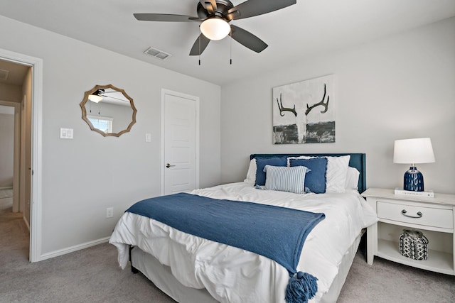 bedroom featuring light carpet, a ceiling fan, visible vents, baseboards, and attic access