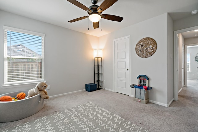 miscellaneous room featuring carpet, baseboards, and a ceiling fan