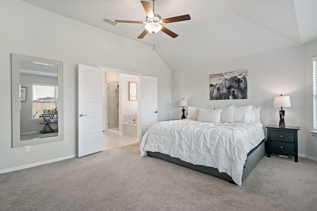 bedroom featuring baseboards, visible vents, connected bathroom, vaulted ceiling, and carpet flooring