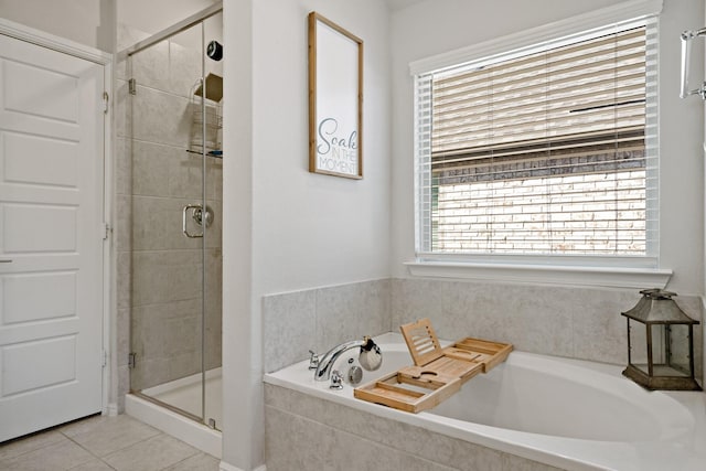 full bathroom featuring a garden tub, tile patterned flooring, and a shower stall