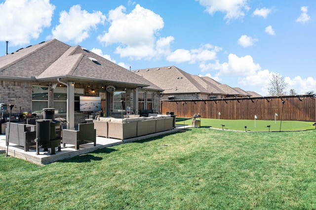 view of yard featuring a patio area, fence, and outdoor lounge area