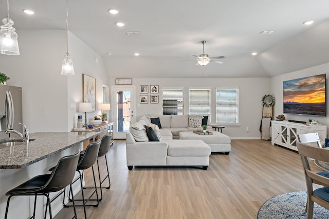 living room with lofted ceiling, light wood-type flooring, a ceiling fan, and recessed lighting