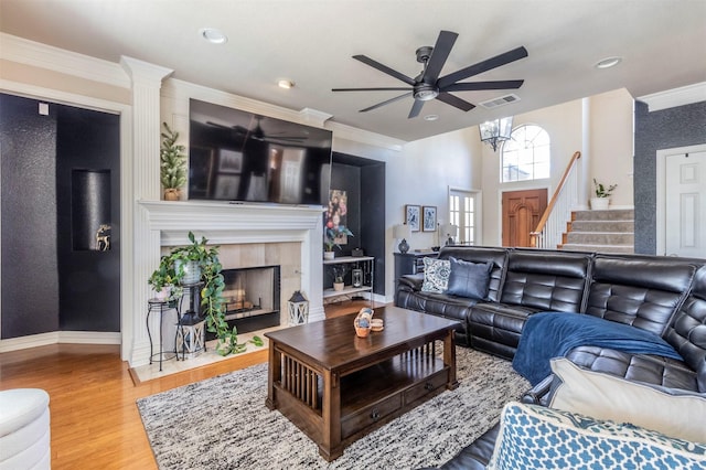5033 Southpoint Dr, Arlington, TX 76017 - living area featuring ceiling fan, wood finished floors, crown molding, stairway, and a tiled fireplace