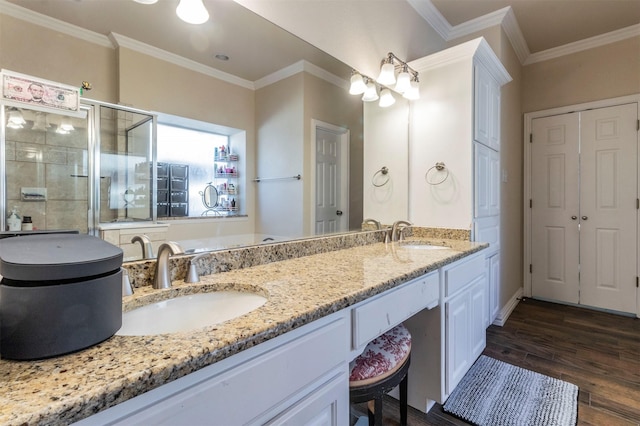 5033 Southpoint Dr, Arlington, TX 76017 - full bath featuring a stall shower, ornamental molding, double vanity, wood finished floors, and baseboards