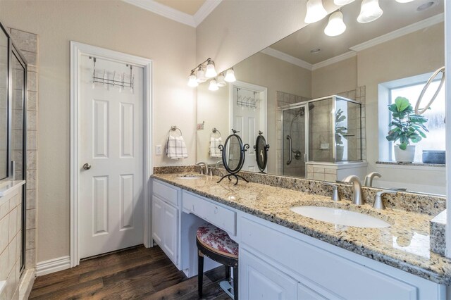 5033 Southpoint Dr, Arlington, TX 76017 - full bathroom featuring a stall shower, crown molding, wood finished floors, double vanity, and a chandelier