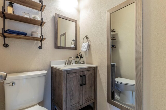 5033 Southpoint Dr, Arlington, TX 76017 - bathroom featuring toilet, vanity, and a textured wall